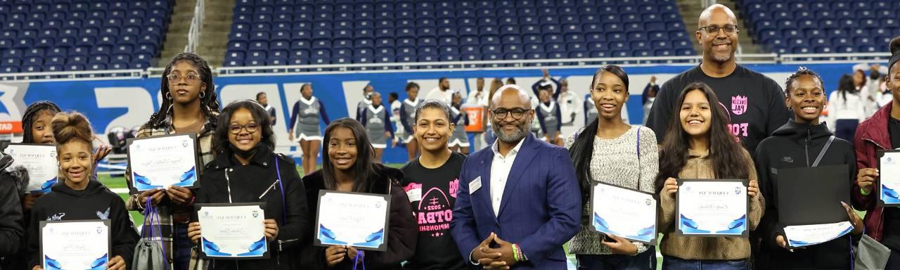 GVSU Vice President for Enrollment Development and Educational Outreach Dr Truss with students at Ford field